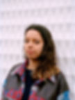 Tirzah photographed against white wall
